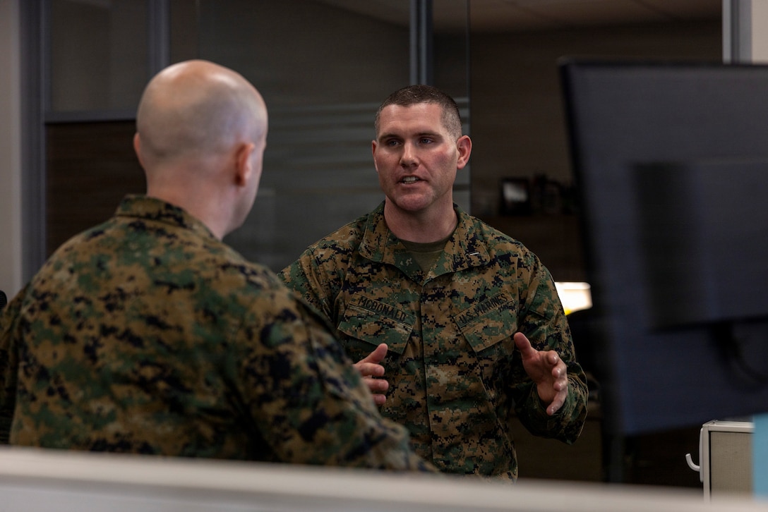 U.S. Marine Corps 2nd Lt. Christopher Griffeth, left, a Florida native and cyberspace environment coordinator with 1st Network Battalion, Marine Corps Cyberspace Operations Group, and 1st Lt. Patrick McDonald, a Michigan native and defensive cyberspace operations officer-in-charge with 9th Communication Battalion, I Marine Expeditionary Force Information Group, coordinate current operations in the Network and Security Operations Center at Marine Corps Base Camp Pendleton, California, Feb. 4, 2026. 9th Comm Bn. and 1st Net Bn. are piloting integrated network and security operations to enhance teamwork across communications and defensive cyber personnel assigned to the Fleet Marine Forces and Service cyber component. (U.S. Marine Corps photo by Sgt. Sean Potter)