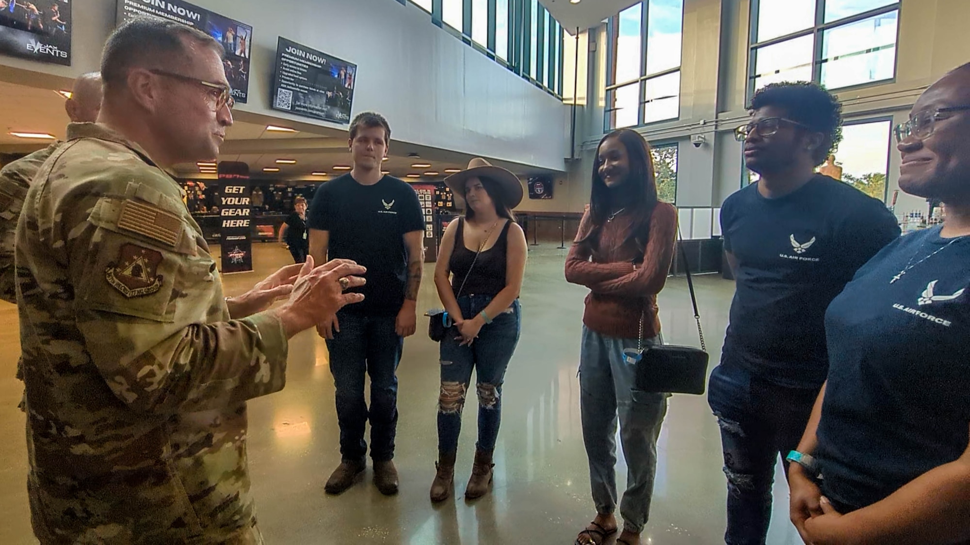Col. Sean "Metro" Fellows, 367th Recruiting Group commander, Robins Air Force Base, Georgia, engages several new recruits before an Oath of Enlistment Ceremony held during the Professional Bull Riders’ Unleash the Beast tour, Feb. 21, 2026, Jacksonville, Florida. U.S. Air Force recruiters from the Air Force Reserve, Air National Guard, and active duty Air Force gathered to honor the sacrifice and commitment of the future Airmen.  (U.S. Air Force photo by Tech. Sgt. Della Creech)