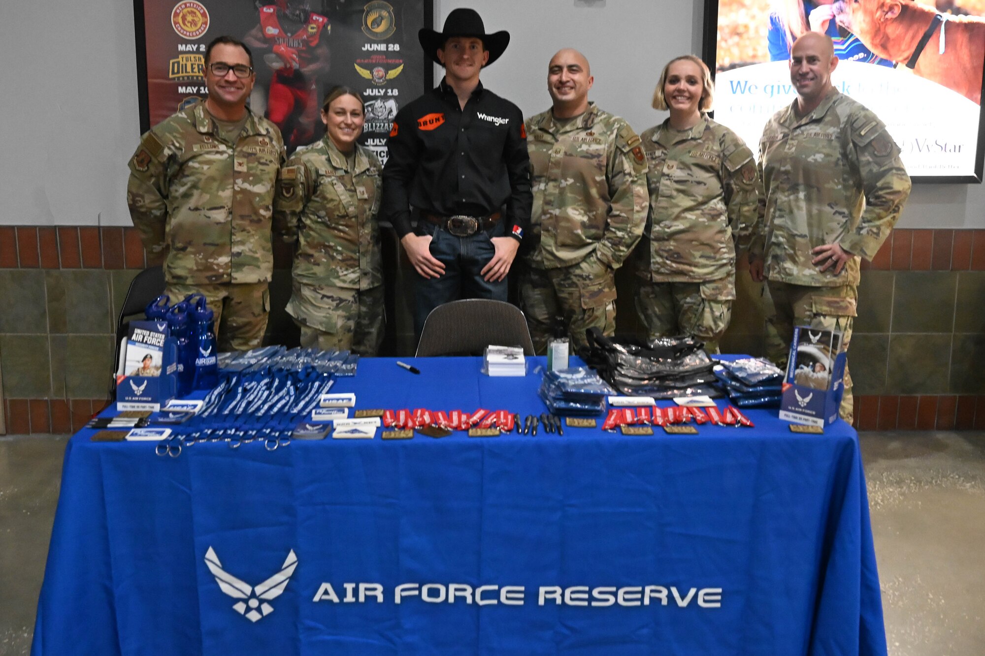 (From left) Col. Sean "Metro" Fellows, 367th Recruiting Group commander, Robins Air Force Base, Georgia, Tech. Sgt. Allyson Bailey, production recruiter, Headquarters Florida Air National Guard, Cort McFadden, professional bullrider, Texas, Master Sgt. Charles Robar, flight chief, 336th Recruiting Squadron, Tech. Sgt. Samantha Baker, medical accessions noncommissioned officer, HQ Florida ANG, and Chief Master Sgt. Derek Hudson, 367th Recruiting Group senior enlisted leader, Robins AFB, Ga. pose at Air Force booth before the Oath of Enlistment Ceremony held for new recruits during the Professional Bull Riders’ Unleash the Beast tour, Feb. 20, 2026, Jacksonville, Florida. U.S. Air Force recruiters from the Air Force Reserve, Air National Guard, and active duty Air Force gathered to engage, inspire, and recruit as a total force. (U.S. Air Force photo/video by Tech. Sgt. Della Creech)