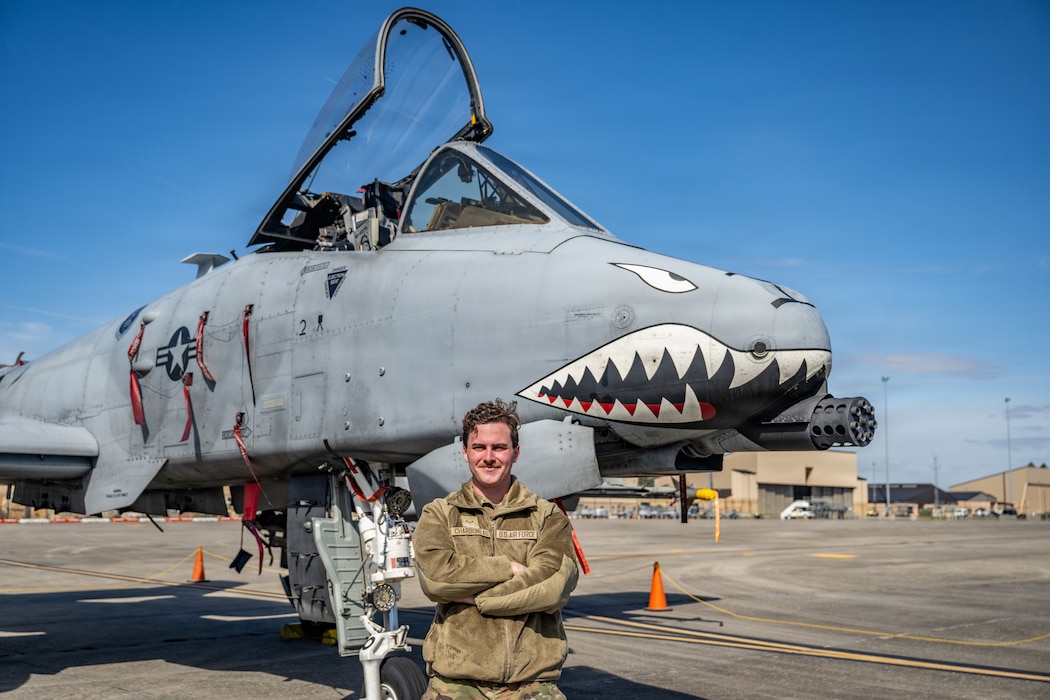 A U.S. Air Force Airman assigned to the 23d Wing poses for a photo during Saluting Our Aviation Roots (SOAR) at Moody Air Force Base, Georgia, Feb. 25, 2026. The Airman explained his role to local students as a maintainer on the A-10C Thunderbolt II. (U.S. Air Force photo by Senior Airman Savannah Carpenter)