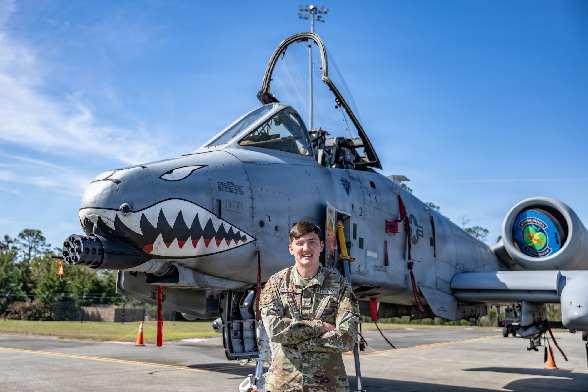 A U.S. Air Force Airman assigned to the 23d Wing poses for a photo during Saluting Our Aviation Roots (SOAR) at Moody Air Force Base, Georgia, Feb. 25, 2026. The Airman discusses his role to local students in ensuring the A-10C Thunderbolt II remains mission ready. (U.S. Air Force photo by Senior Airman Savannah Carpenter)