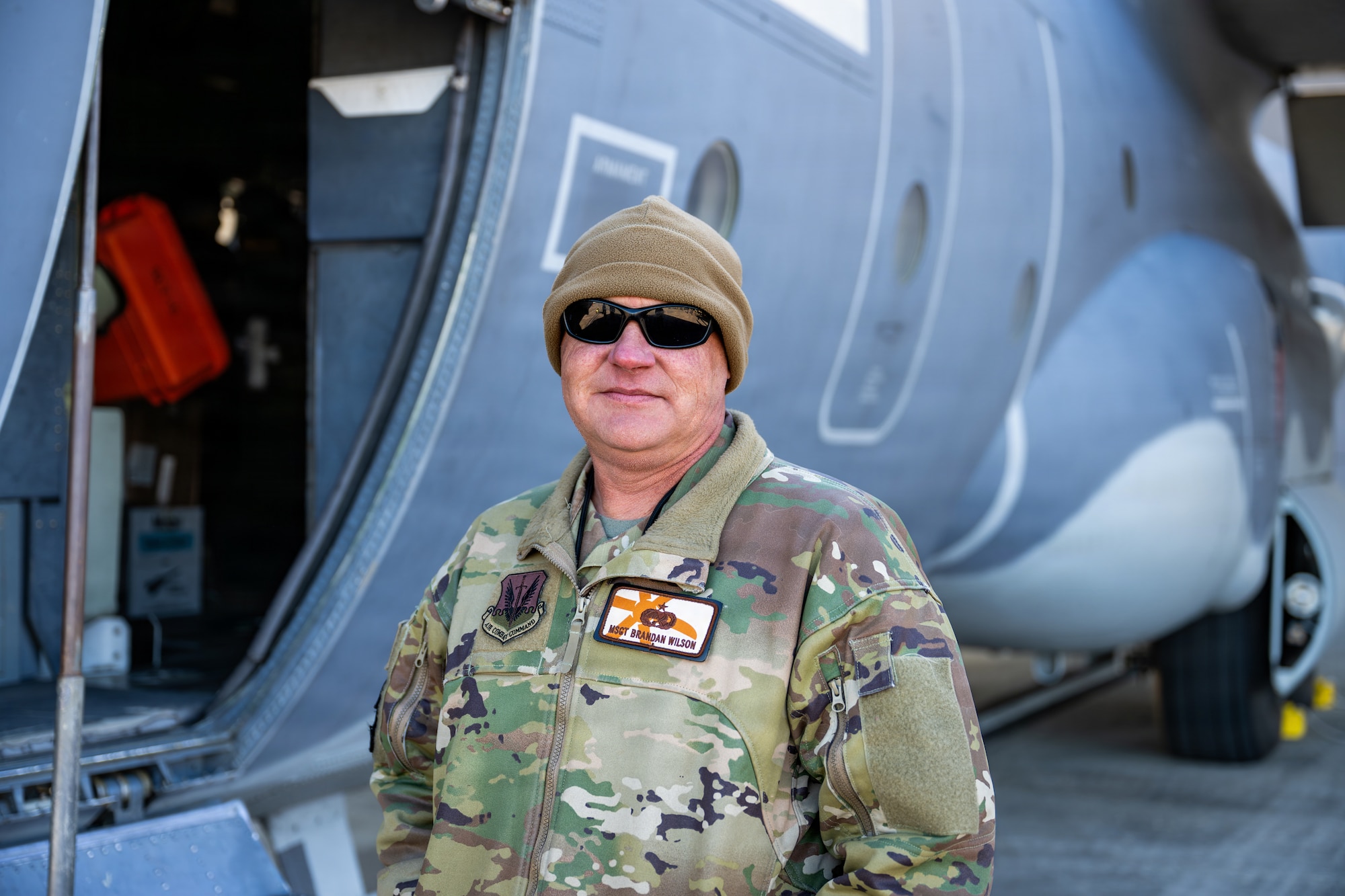 U.S. Air Force Master Sgt. Brandan Wilson, 71st Rescue Generation Squadron maintainer, poses for a portrait during the Saluting Our Aviation Roots static display at Moody Air Force Base, Georgia, Feb. 24, 2026. Wilson helped attendees tour the HC-130J Combat King II. (U.S. Air Force photo by Airman 1st Class Rachel Howell)