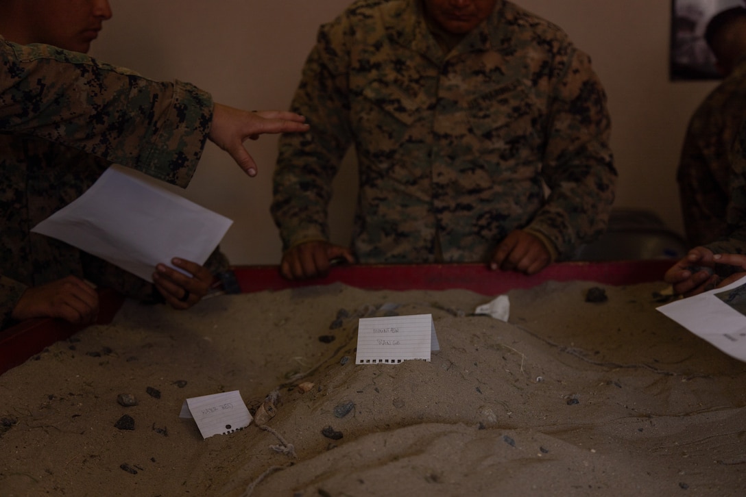 U.S. Marines with Marine Wing Support Squadron 371, Marine Air Control Group 38, 3rd Marine Aircraft Wing, build a terrain model during a company field exercise at Marine Corps Base Camp Pendleton, California, Feb. 24, 2026. The exercise demonstrated the unit’s ability to sustain ground transportation operations for 3rd MAW in support of the Marine Air Ground Task Force. (U.S. Marine Corps photo by Lance Cpl. Samantha Devine)