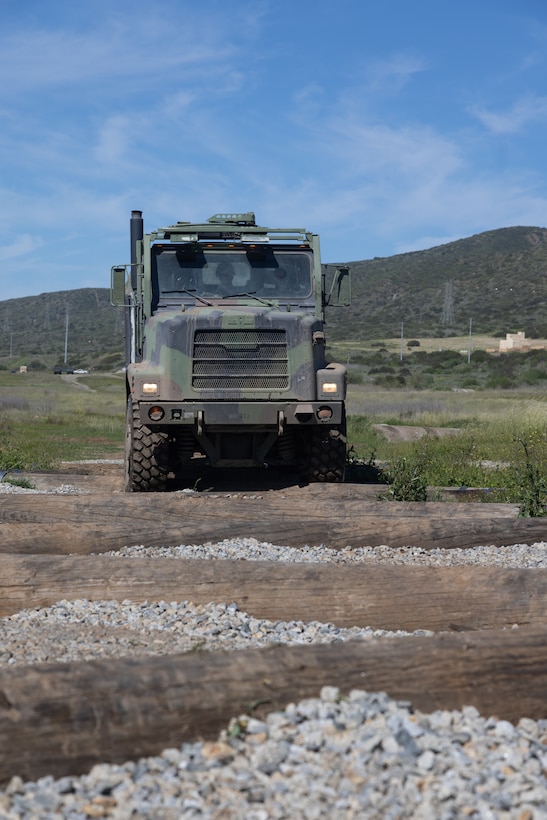 U.S. Marines with Marine Wing Support Squadron 371, Marine Air Control Group 38, 3rd Marine Aircraft Wing, operate a MK27 long wheelbase cargo variant in the combat vehicle operator training lanes during a company field exercise at Marine Corps Base Camp Pendleton, California, Feb. 25, 2026. The exercise demonstrated the unit’s ability to sustain ground transportation operations for 3rd MAW in support of the Marine Air Ground Task Force. ​(U.S. Marine Corps photo by Lance Cpl. Samantha Devine)