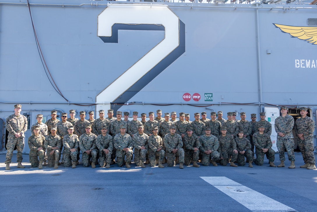 U.S. Marines with Marine Wing Support Squadron 371, Marine Air Control Group 38, 3rd Marine Aircraft Wing, pose for photo aboard the Wasp-class amphibious assault ship USS Essex (LHD 2) at Naval Base San Diego, California, Feb. 26, 2026. The visit was conducted to prepare Marines for ship life and increase naval integration. (U.S. Marine Corps photo by Lance Cpl. Samantha Devine)