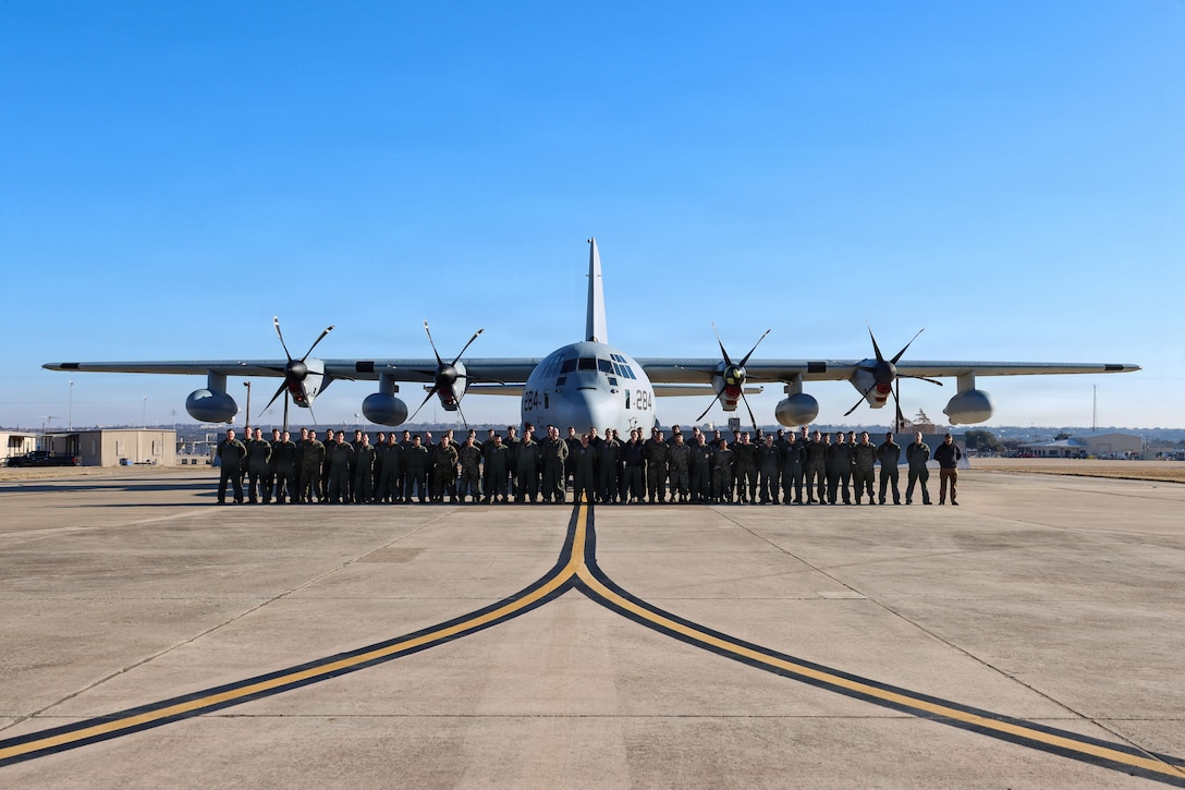U.S. Marines with Marine Aerial Refueler Transport Squadron (VMGR) 153, Marine Aircraft Group 24, 1st Marine Aircraft Wing, pose for a group photo in front of a KC-130J during a deployment for training (DFT) at Naval Air Station Joint Reserve Base Fort Worth, Texas, Feb. 16, 2026. The DFT accomplished unit level training objectives away from home station for both flight crew and maintenance and enhanced interoperability in a simulated contested environment. (U.S. Marine Corps photo by Cpl. Anabelle Reed-O’Brien)