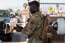 An SFS Airman scans IDs at the gate