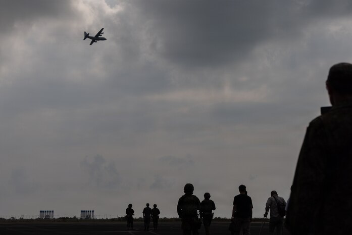 Simulated evacuees move toward a military aircraft for transport during a noncombatant evacuation operation exercise at U-Tapao Airport, Thailand, Feb. 26, 2026