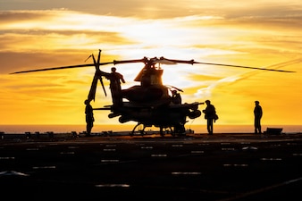 U.S. Marines, assigned to Marine Medium Tiltrotor Squadron (VMM) 163 (Reinforced), 11th Marine Expeditionary Unit, conduct post flight checks on an AH-1Z Viper on the flight deck of Wasp-class amphibious assault ship USS Boxer (LHD 4), Feb. 24, 2026. Boxer, flagship of the Boxer Amphibious Ready Group, is underway with the 11th MEU in the U.S. 3rd Fleet area of operations conducting integrated training that enhances warfighting capability and tactical proficiency. (U.S. Navy photo by Mass Communication Specialist 2nd Class Normand Basque)