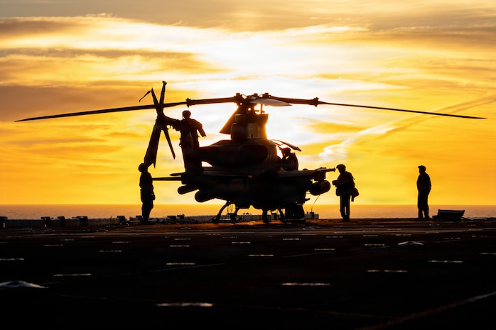 U.S. Marines, assigned to Marine Medium Tiltrotor Squadron (VMM) 163 (Reinforced), 11th Marine Expeditionary Unit, conduct post flight checks on an AH-1Z Viper on the flight deck of Wasp-class amphibious assault ship USS Boxer (LHD 4), Feb. 24, 2026. Boxer, flagship of the Boxer Amphibious Ready Group, is underway with the 11th MEU in the U.S. 3rd Fleet area of operations conducting integrated training that enhances warfighting capability and tactical proficiency. (U.S. Navy photo by Mass Communication Specialist 2nd Class Normand Basque)