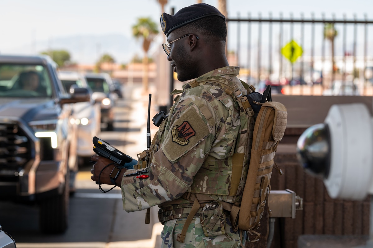 An SFS Airman scans IDs at the gate