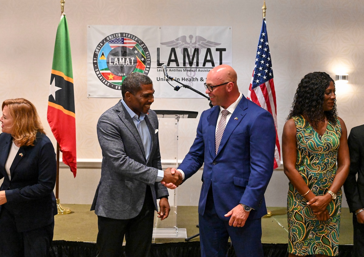 Saint Kitts and Nevis Prime Minister Dr. Terrance Drew, left, shakes hands with U.S. Air Force Lt. Col. Barry Davis, general surgeon and LAMAT 2026 mission commander, after the Lesser Antilles Medical Assistance Team (LAMAT) 2026 opening ceremony, in Basseterre, Saint Kitts on Feb. 22, 2026. The engagement reinforces sustained medical collaboration and shared preparedness. (U.S. Air Force Photo by Staff Sgt. Dakota Carter)