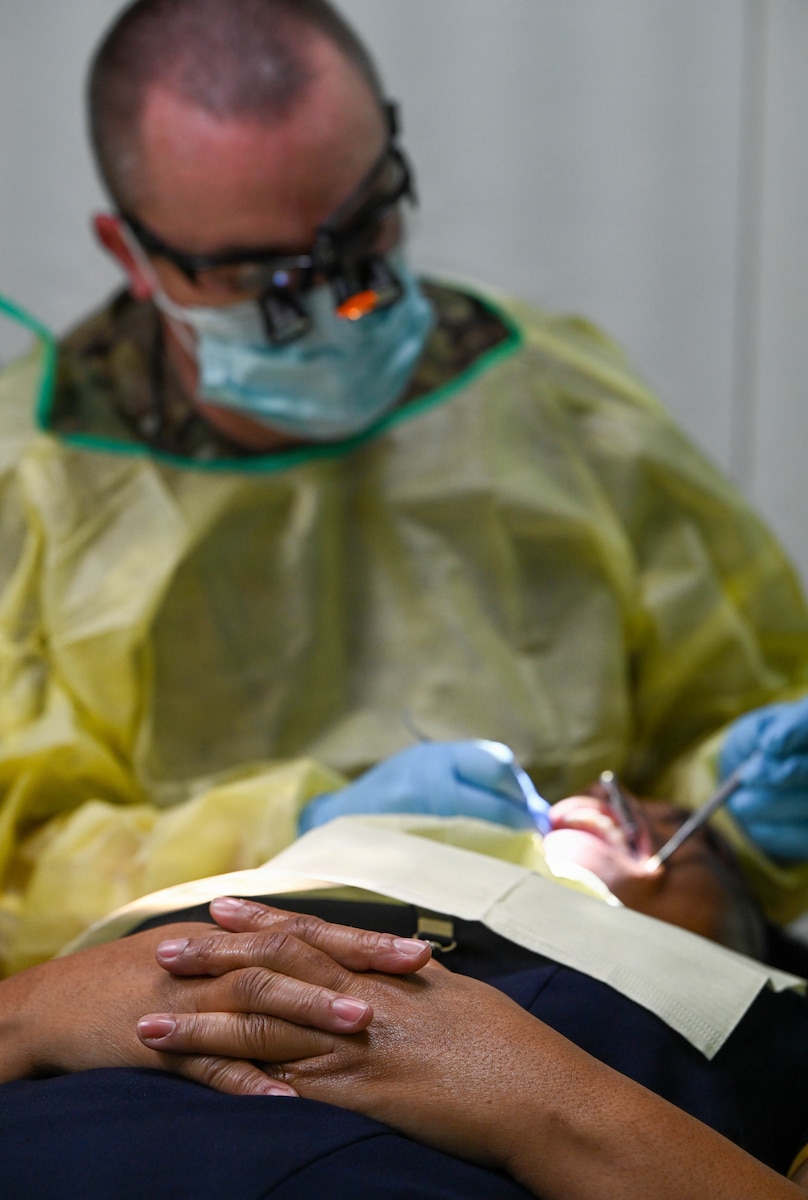 U.S. Air Force Reserve Maj. Andrew Hutchison, 419th Medical Squadron officer-in-charge of the Nevis dental team, performs a filling repair on a Nevisian patient at Charlestown Dental Clinic in Charlestown, Nevis, Feb. 24, 2026. This procedure was part of the Lesser Antilles Medical Assistance Team 2026 mission, which supports partner nations through medical outreach while strengthening deployed medical readiness and adaptability among participating Airmen. (U.S. Air Force Photo by Staff Sgt. Dakota Carter)