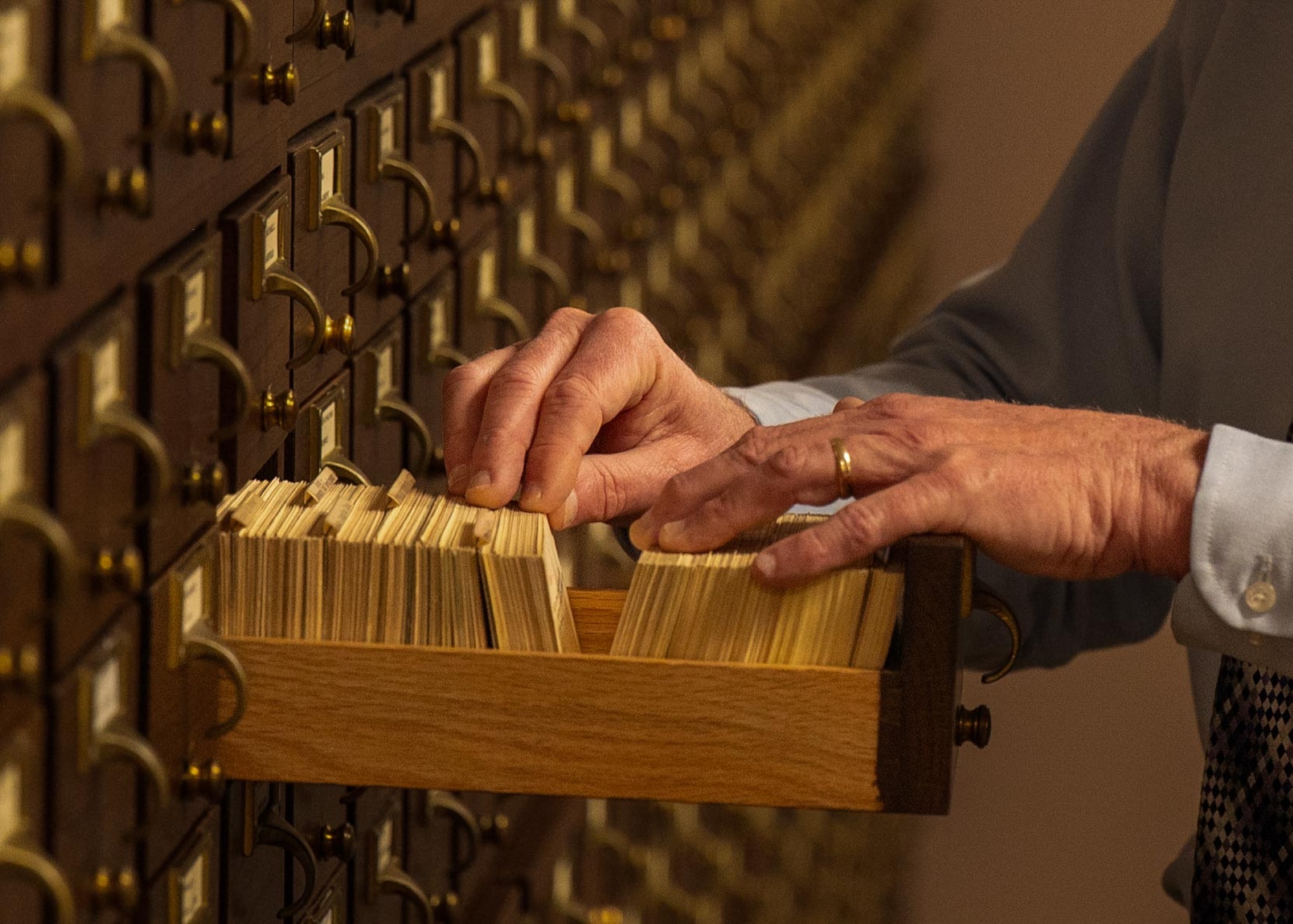 Samuel Shearin, Air Force Historical Research Agency lineage, honors and heraldry division historian, searches through a card catalog at Maxwell Air Force Base, Alabama, Feb. 26, 2026.