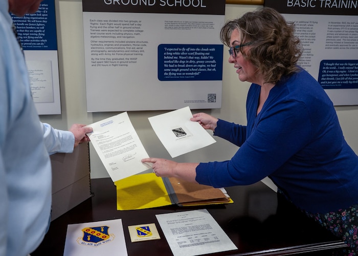 Melissa Lahue, Air Force Historical Research Agency research division chief, and Samuel Shearin, AFHRA lineage, honors and heraldry division historian, demonstrate and explain the importance of the linage of the 42d Air Base Wing’s emblem at Maxwell Air Force Base, Alabama, Feb. 26, 2026