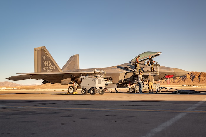 A military aircraft sitting on a flightline.