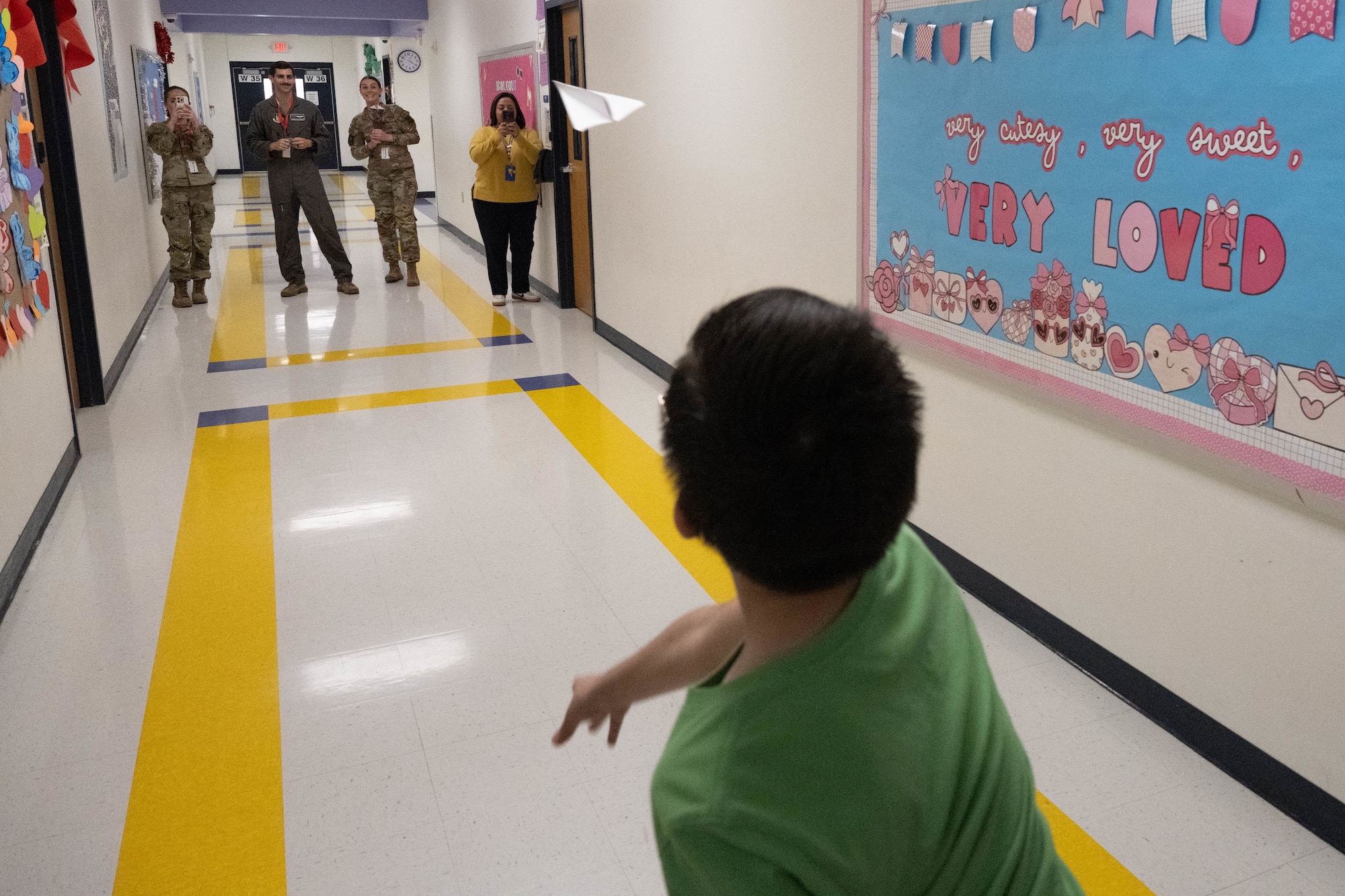 A Lamar Elementary School student throws a paper airplane down a hallway at Del Rio, Texas, Feb. 19, 2026. Students competed in a paper airplane competition as part of the Laughlin Buddies afterschool program. (U.S. Air Force photo by Airman 1st Class Darryl Keith)