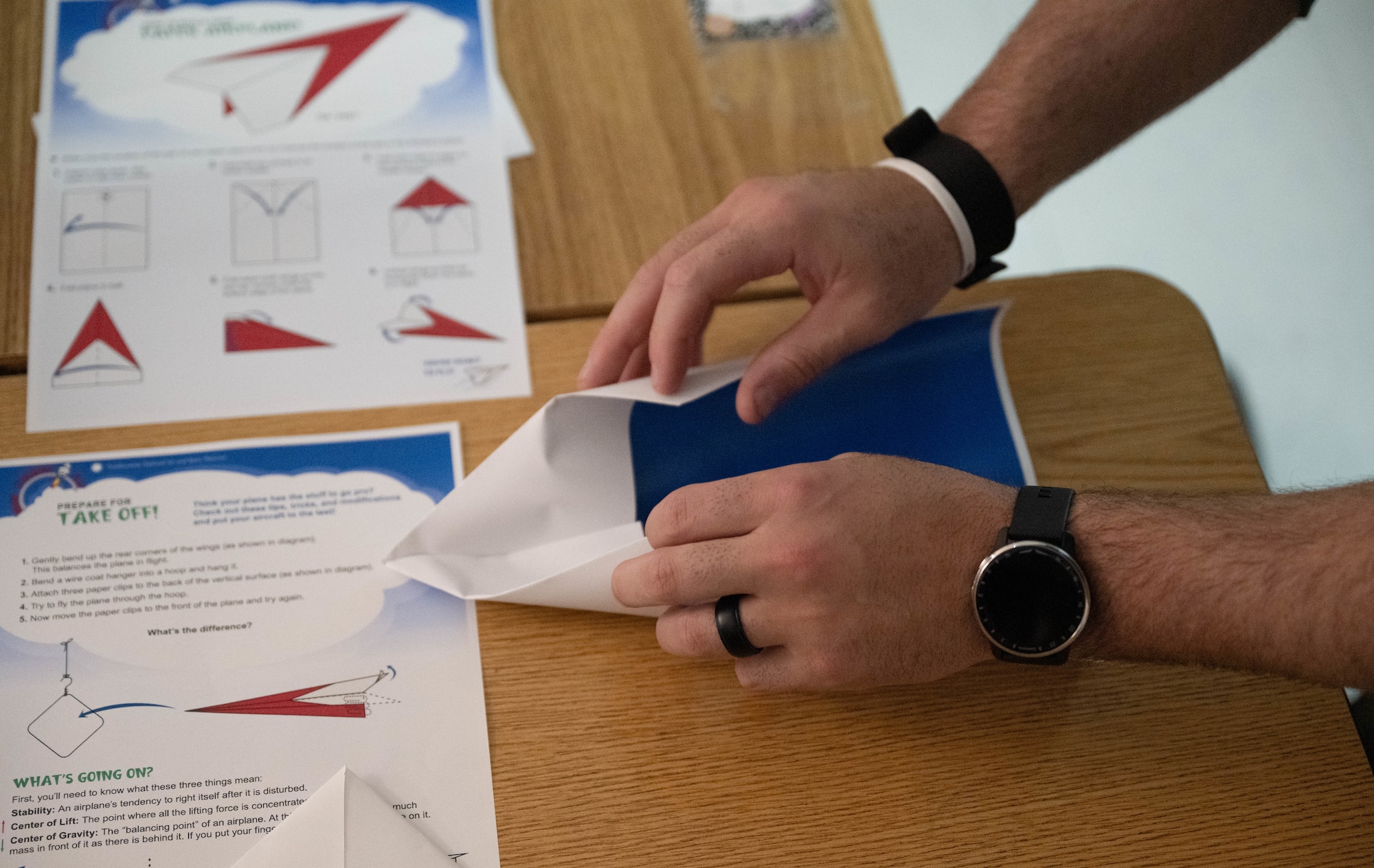 U.S. Air Force 1st Lt. Alex Osborn, 87th Flying Training Squadron T-38 instructor pilot, creates a paper airplane at Lamar Elementary School in Del Rio, Texas, Feb. 19, 2026. Osborn participated in the Laughlin Buddies afterschool program to educate students about his profession. (U.S. Air Force photo by Airman 1st Class Darryl Keith)