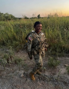 U.S. Army Spc. Sanaa Drinks, a Soldier with the New Jersey Army National Guard, poses for a picture during a ruck march at Fort Sill, Oklahoma.