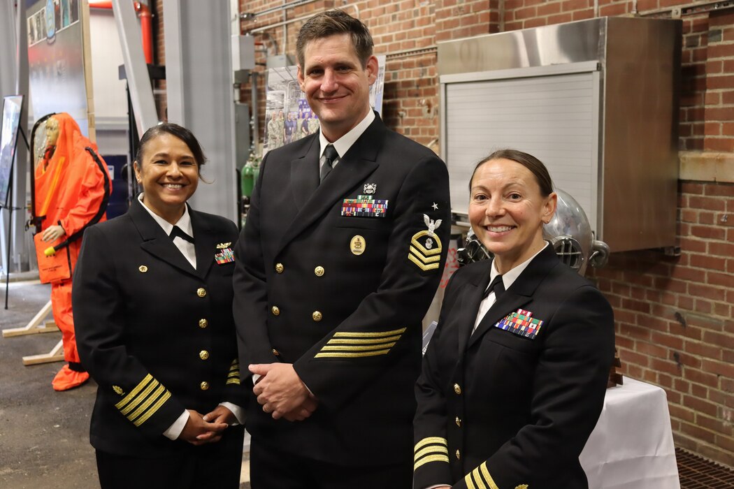 GROTON, Conn. (Nov. 6, 2025) Capt. Tatana Olson, commanding officer, Senior Chief Navy Diver Michael Bailey, senior enlisted leader; and Cmdr. Tara Smallidge, executive officer, all triad members of Naval Submarine Medical Research Laboratory (NSMRL) at the Genesis Chamber certification event. NSMRL, part of Navy Medicine Research & Development and based out of Groton, Connecticut, sustains the readiness and superiority of U.S. undersea warfighters through innovative health and performance research and works to lead the world in delivering science solutions to ensure undersea warrior dominance. (U.S. Navy photo by Emily Swedlund /Released)