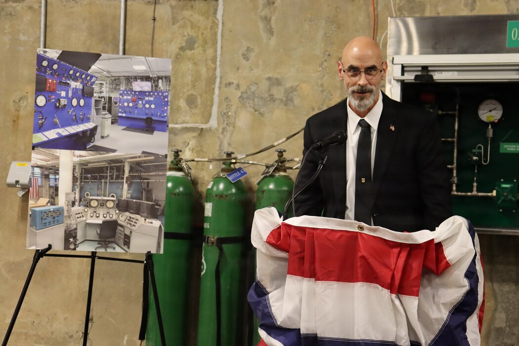 GROTON, Conn. (Nov. 6, 2025) Louis Deflice of Naval Submarine Medical Research Laboratory (NSMRL) speaks on the history of the Genesis Chamber. NSMRL, part of Navy Medicine Research & Development and based out of Groton, Connecticut, sustains the readiness and superiority of U.S. undersea warfighters through innovative health and performance research and works to lead the world in delivering science solutions to ensure undersea warrior dominance. (U.S. Navy photo by Emily Swedlund /Released)