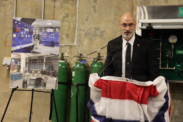GROTON, Conn. (Nov. 6, 2025) Louis Deflice of Naval Submarine Medical Research Laboratory (NSMRL) speaks on the history of the Genesis Chamber. NSMRL, part of Navy Medicine Research & Development and based out of Groton, Connecticut, sustains the readiness and superiority of U.S. undersea warfighters through innovative health and performance research and works to lead the world in delivering science solutions to ensure undersea warrior dominance. (U.S. Navy photo by Emily Swedlund /Released)