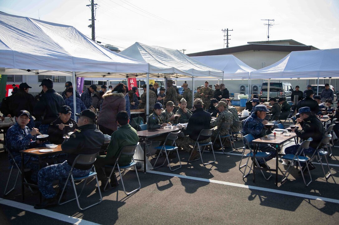 The Marine Corps Air Station Iwakuni community participates in a traditional Mochitsuki mochi pounding event at Marine Corps Air Station Iwakuni, Japan, Dec. 19, 2025. Fleet Air Wing 31 Iwakuni hosted a traditional annual Mochitsuki event with AIMD for the MCAS Iwakuni community to participate and learn more about Japanese New Year’s traditions and culture. (U.S. Marine Corps photo by Lance Cpl. Tyler Bassett)