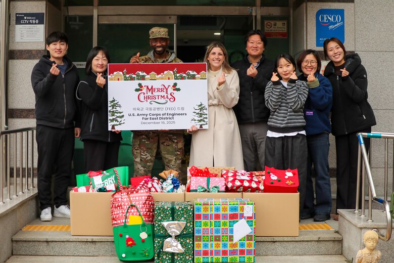 U.S. Army Corps of Engineers – Far East District (FED) employees visit Sungyook Children’s Home, located in Pyeongtaek, South Korea, to deliver holiday gifts donated by FED employees, Dec. 16, 2025. The employees pose with the home’s managers in front of the building for the fifth consecutive year of FED's community outreach efforts for the facility.  (U.S. Army photo by Monique Freemon)