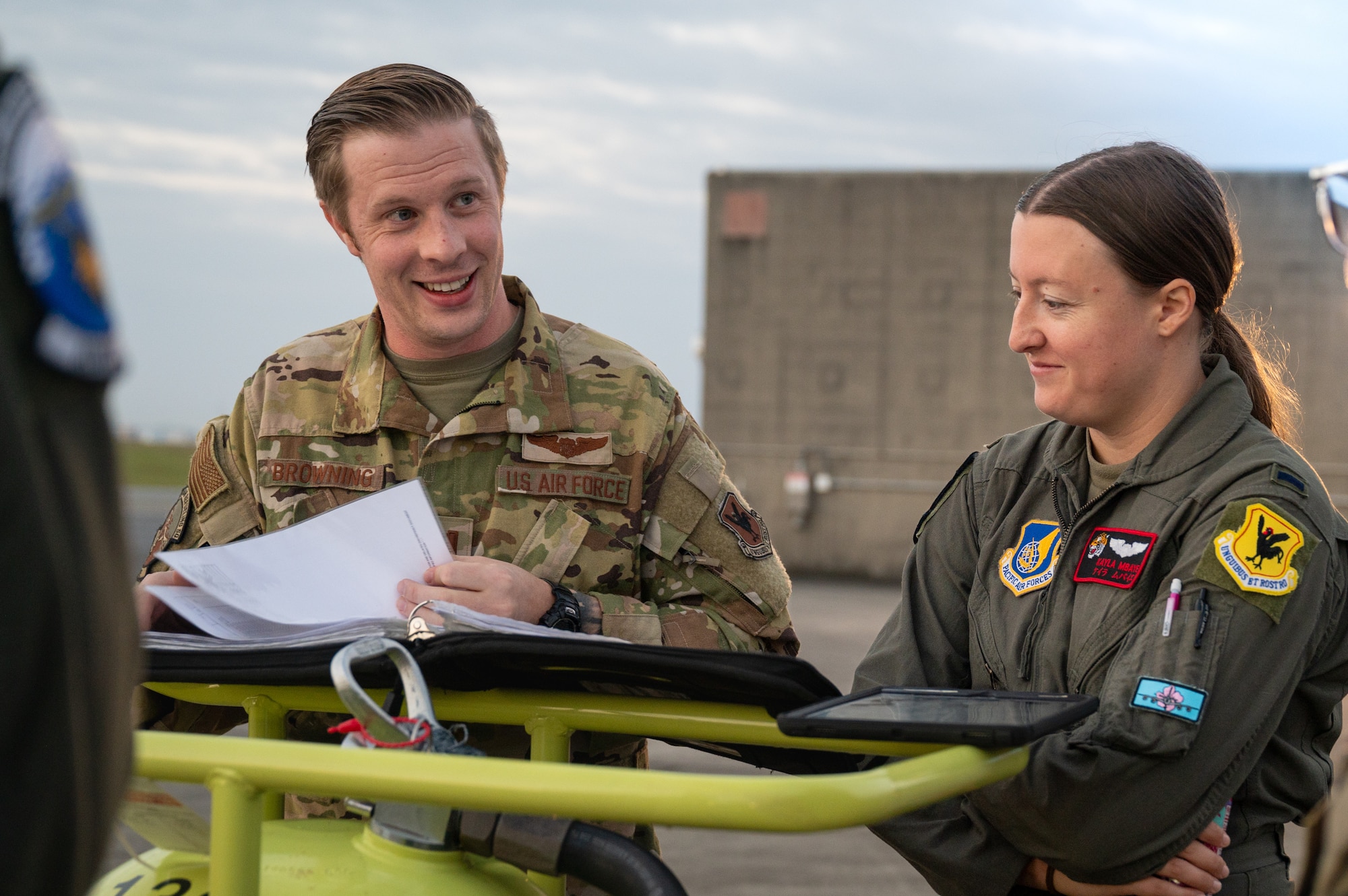 Two pilots conduct a preflight brief prior to a flight.