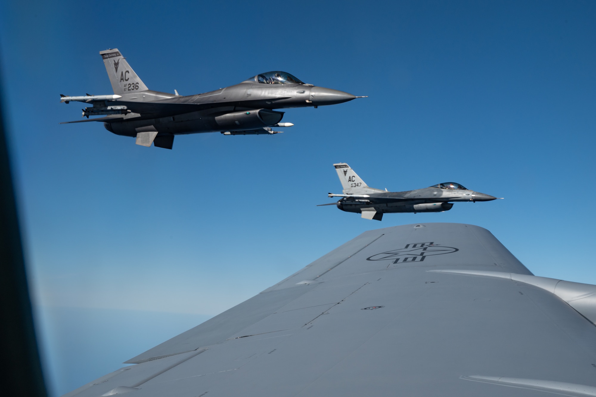 Fighter aircrafts wait for an aerial refueling.