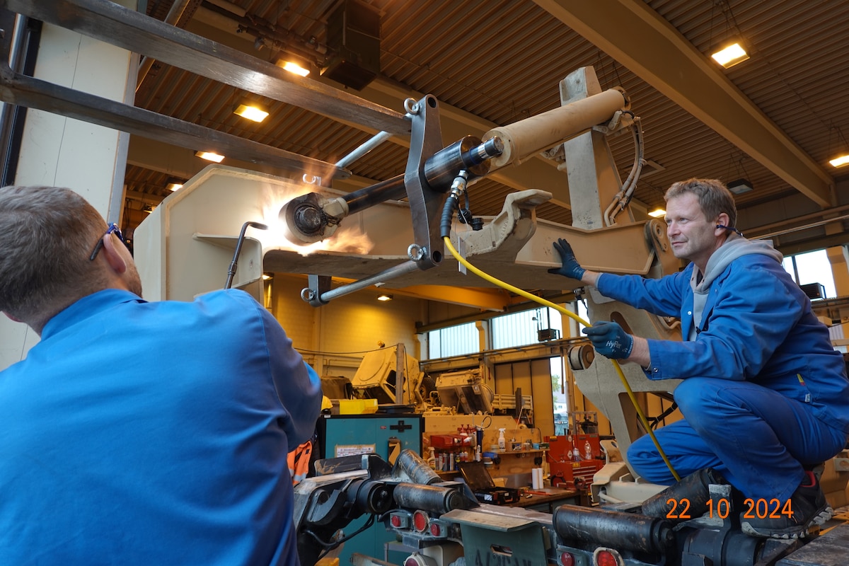 Maintenance Activity Vilseck mechanics remove a frozen LHS arm pin using heat treatment and mechanical force.