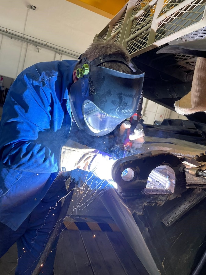 Maintenance Activity Vilseck welder performs structural welding on an M1A2 main battle tank hull mounting bracket at the Coleman Work Site