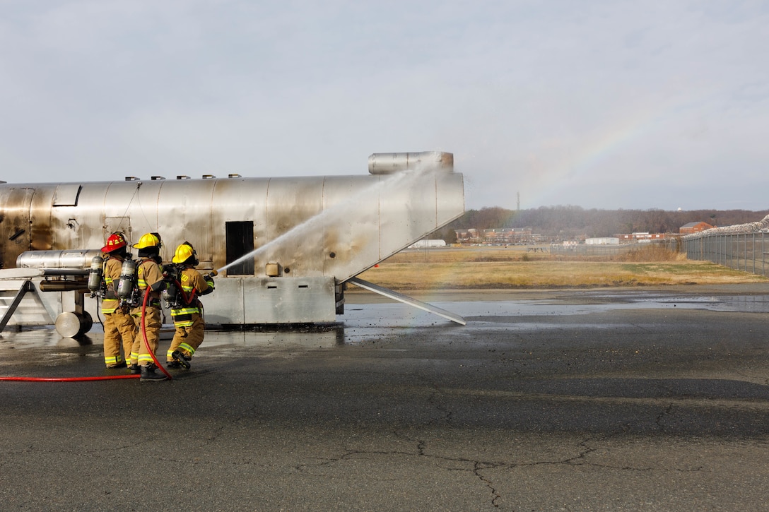 U.S. Marines with Aircraft Rescue and Firefighting, Marine Corps Air Facility Quantico, participate in a training fires exercise at MCAF on Marine Corps Base Quantico, Virginia, Dec. 12, 2025. Training for aircraft fires is an integral part of maintaining readiness for ARFF Marines in order to prepare them for real life situations they might face by building repetition in set procedures. (U.S. Marine Corps photo by Lance Cpl. Lynsee Avila-Ramirez)