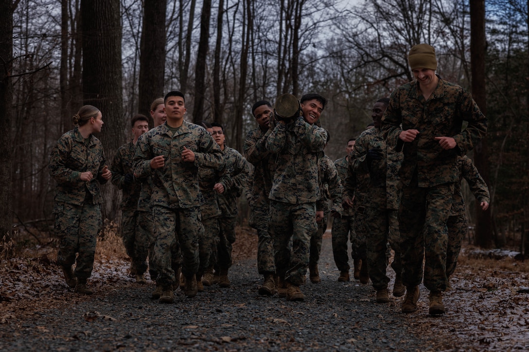 U.S. Marines with Corporals Course 1-26 conduct a log carry during the Montford Point Challenge at the Officer Candidate School on Marine Corps Base Quantico, Virginia, Dec. 16, 2025. The Montford Point Challenge was the culminating event for Corporals Course 1-26 to honor the first African Americans to enlist in the U.S. Marine Corps and further instilled the Marine Corps’ warfighting mentality. (U.S. Marine Corps photo by Lance Cpl. Harleigh Faulk)
