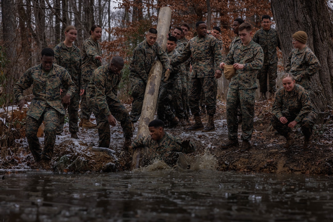 U.S. Marines with Corporals Course 1-26 conduct a log carry during the Montford Point Challenge at the Officer Candidate School on Marine Corps Base Quantico, Virginia, Dec. 16, 2025. The Montford Point Challenge was the culminating event for Corporals Course 1-26 to honor the first African Americans to enlist in the U.S. Marine Corps and further instilled the Marine Corps’ warfighting mentality. (U.S. Marine Corps photo by Lance Cpl. Harleigh Faulk)