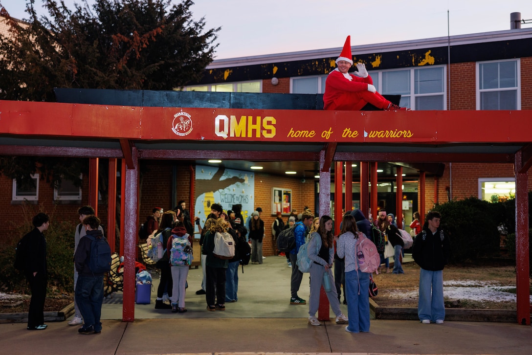Elf on the Shelf greets the students of Quantico Middle/High School on Marine Corps Base Quantico, Virginia, Dec. 17, 2025. Tony Wishard, a school liaison and the man who brings the Elf on the Shelf alive, bore the cold to bring holiday spirit to Quantico’s youth. (U.S. Marine Corps photo by Lance Cpl. David Brandes)