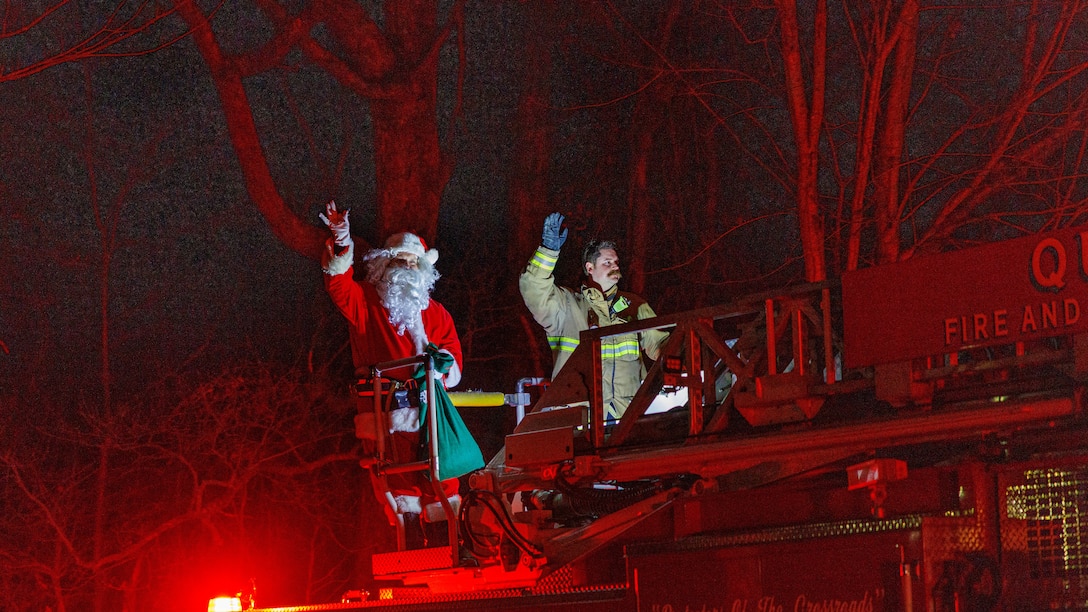 Santa visits families during the 5th Annual Santa Run on Marine Corps Quantico, Virginia, Dec. 20, 2025. The Santa run is an event organized by Station 31 Firefighters to bring holiday cheer to residents aboard MCB Quantico. (U.S. Marine Corps photo by Lance Cpl. Donovan E. Melendez)