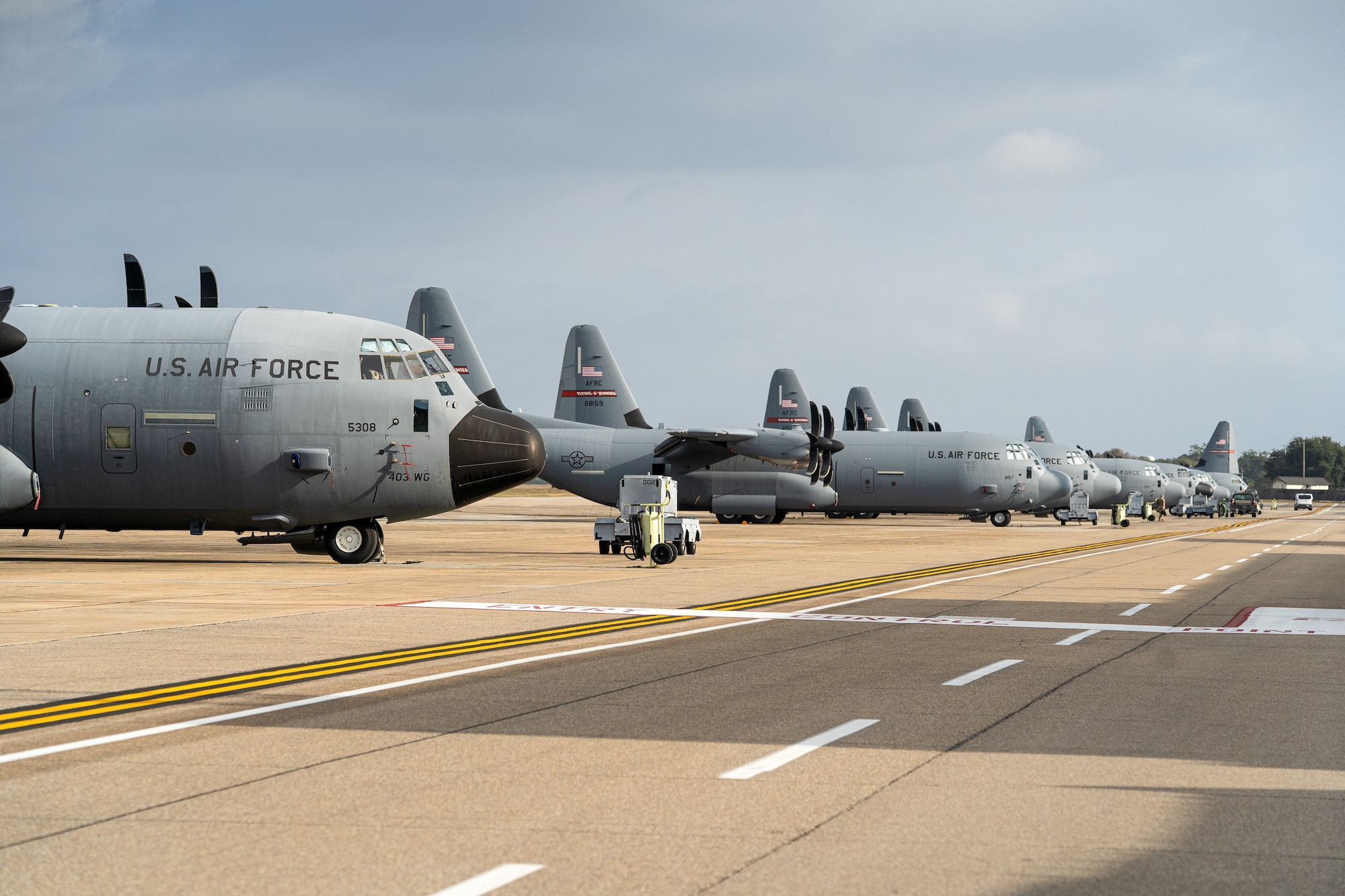 Grey cargo planes on a flight line.