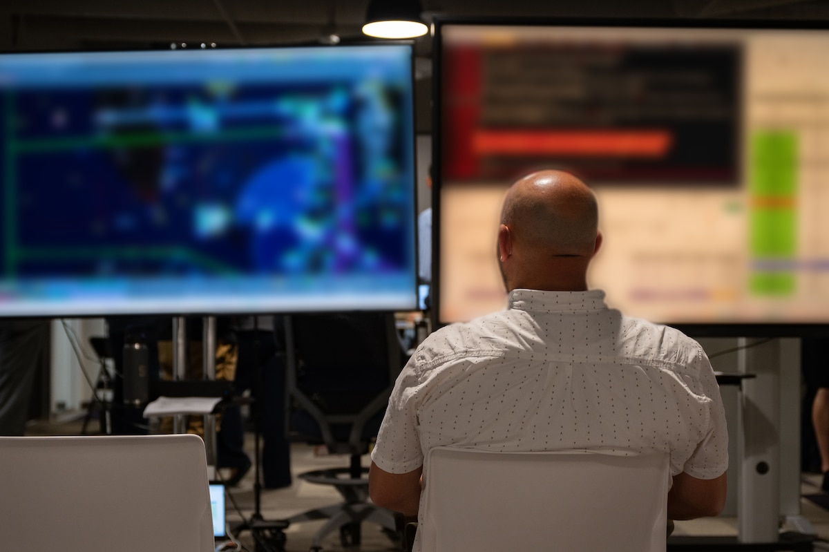 backview of a person working on computers