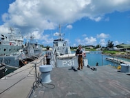 two people standing on the deck of a ship.