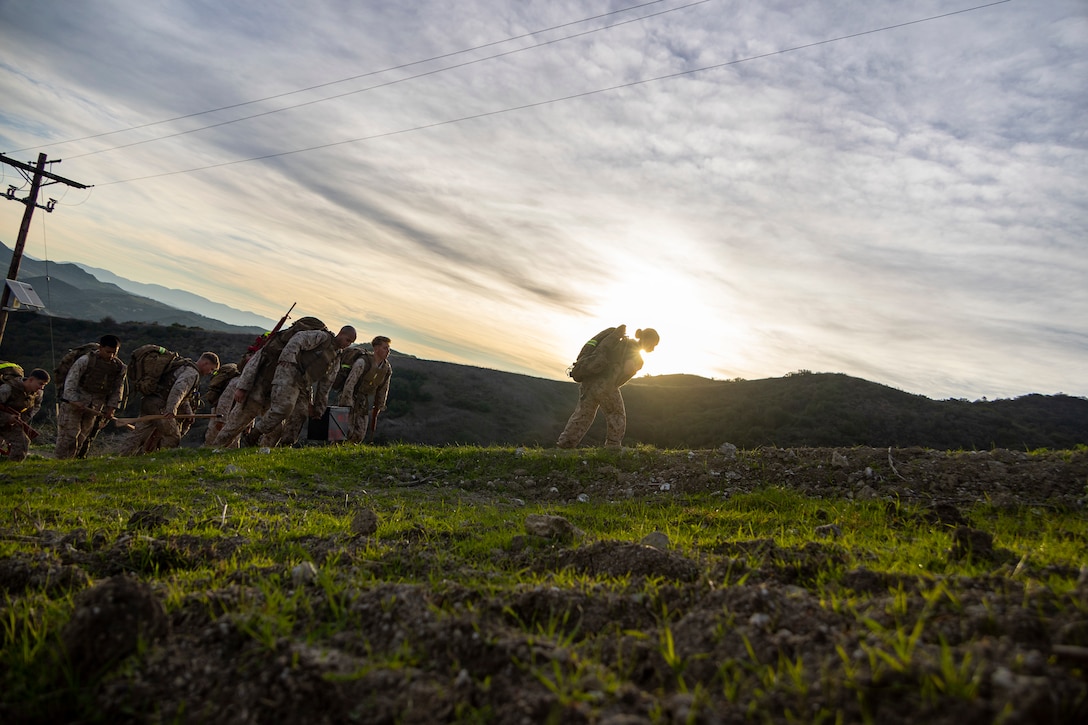 U.S. Marines participate in a supply run during a martial arts instructor course hosted by 1st Intelligence Battalion at Marine Corps Base Camp Pendleton, California, Dec. 18, 2025. The culminating event combines multiple physical training events to ensure Marines are ready to meet the demands of becoming a martial arts instructor. (U.S. Marine Corps photo by Sgt. Sean Potter)