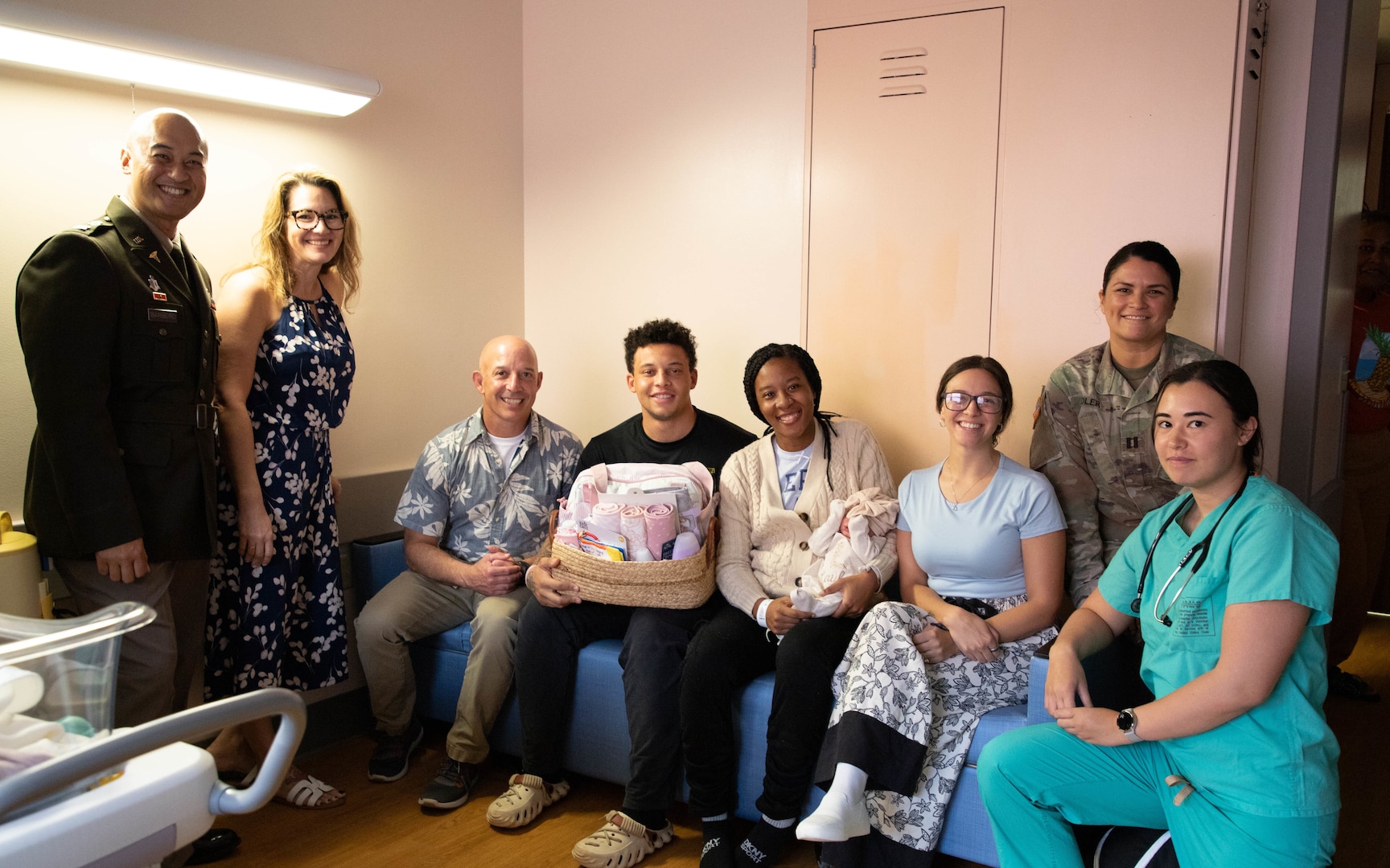 Staff from the Mother Baby Unit at Tripler Army Medical Center, along with Col. William Bimson, commander of TAMC, presented a gift basket to U.S. Army Pfc. LaShawn and Kayla Brabham after the birth of their daughter, Layla Brabham, at TAMC in Honolulu, Hawaii, on Jan. 1, 2026. Layla, born at 5:49 a.m. on New Year’s Day, is TAMC’s first baby girl of 2026. (Defense Health Agency photo by Khinna Kaminske)
