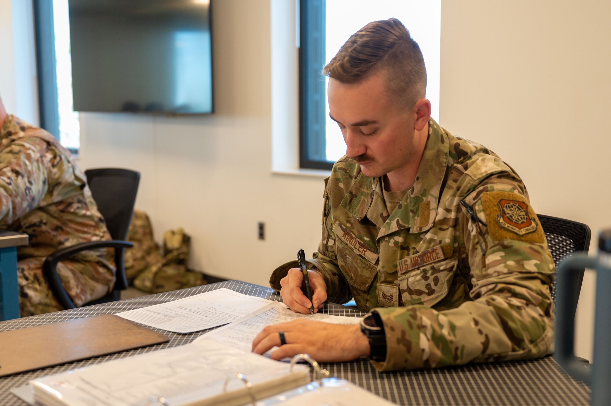 Airman writes on paper