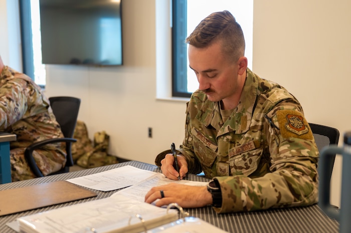 Airman writes on paper