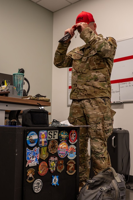 Airman puts on a hat