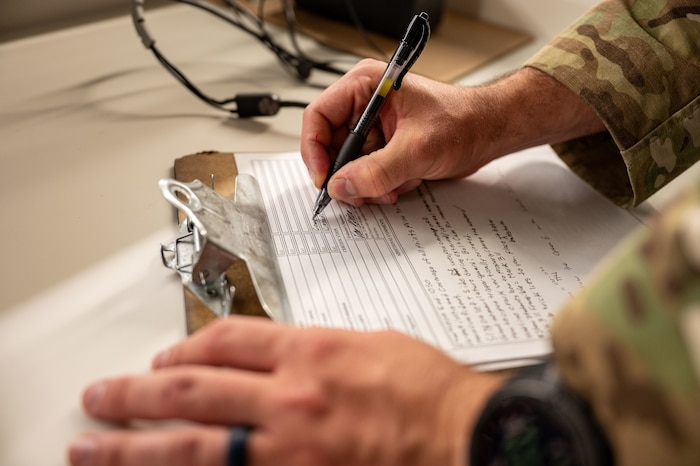 Airman writes on paper