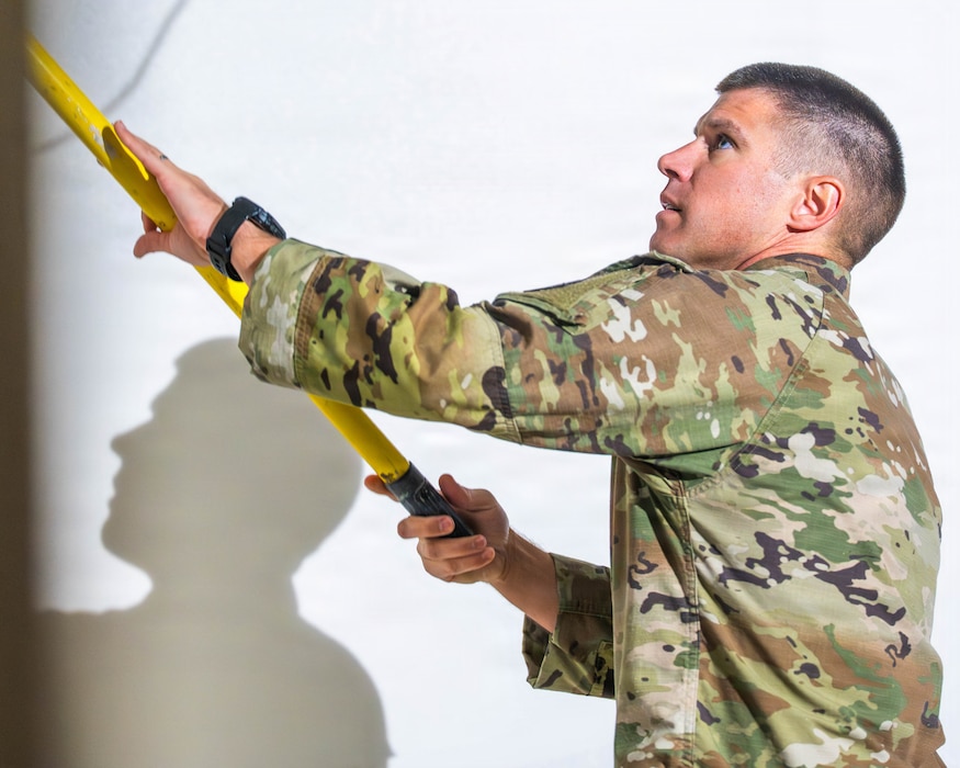 U.S. Air Force Lt. Col. Brandon Delong, 56th Civil Engineer Squadron commander, primes a wall during Fire Station 2 repair operations, Dec. 5, 2025, at Luke Air Force Base, Arizona.