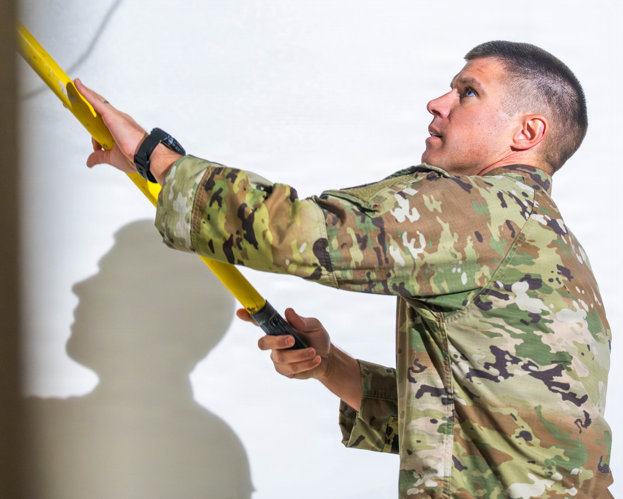 U.S. Air Force Lt. Col. Brandon Delong, 56th Civil Engineer Squadron commander, primes a wall during Fire Station 2 repair operations, Dec. 5, 2025, at Luke Air Force Base, Arizona.
