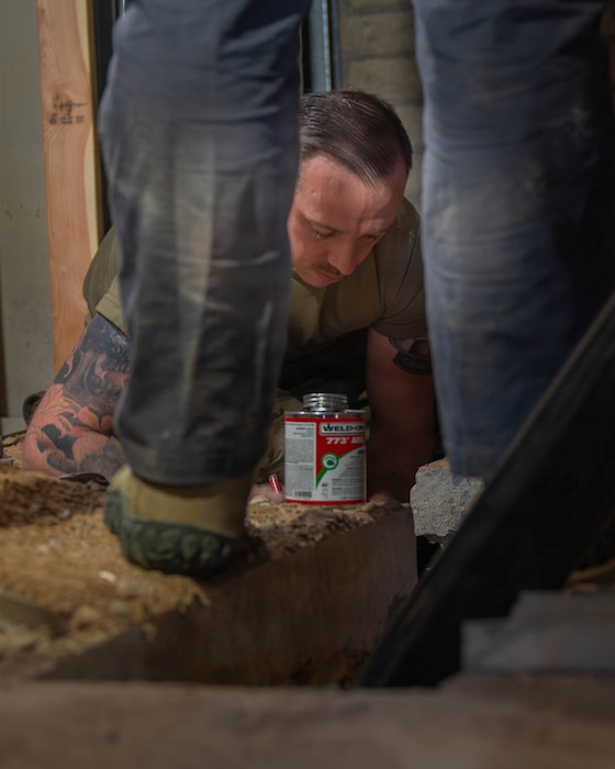 U.S. Air Force Staff Sgt. Alexander Bright, 56th Civil Engineer Squadron water fuels technician, works in a confined space while applying bonding materials as part of Fire Station 2 renovation efforts, Dec. 5, 2025, at Luke Air Force Base, Arizona.