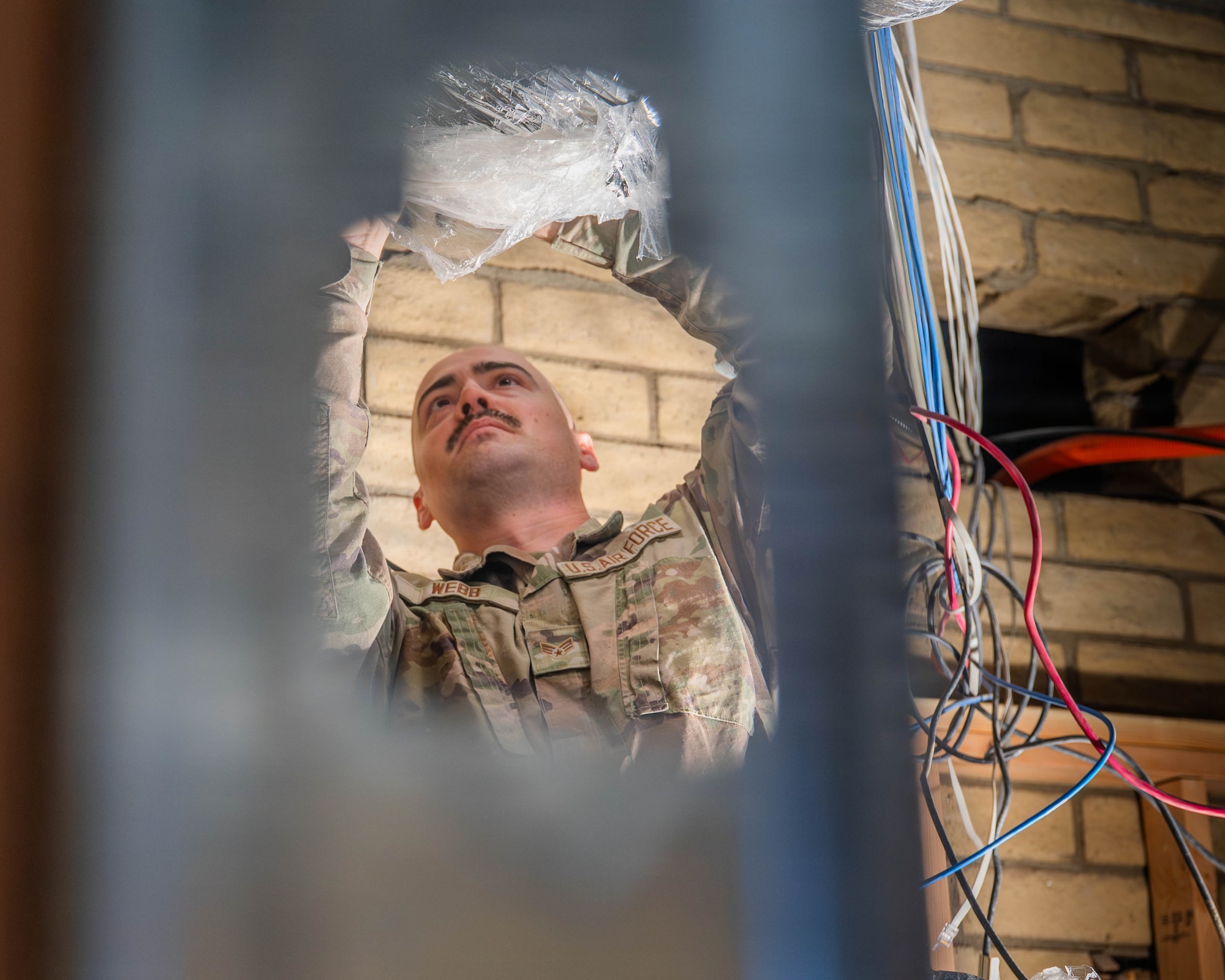 U.S. Air Force Senior Airman Lloyd Nelson Webb, 56th Civil Engineer Squadron HVAC technician, secures wiring inside Fire Station 2 during an ongoing renovation project, Dec. 5, 2025, at Luke Air Force Base, Arizona.